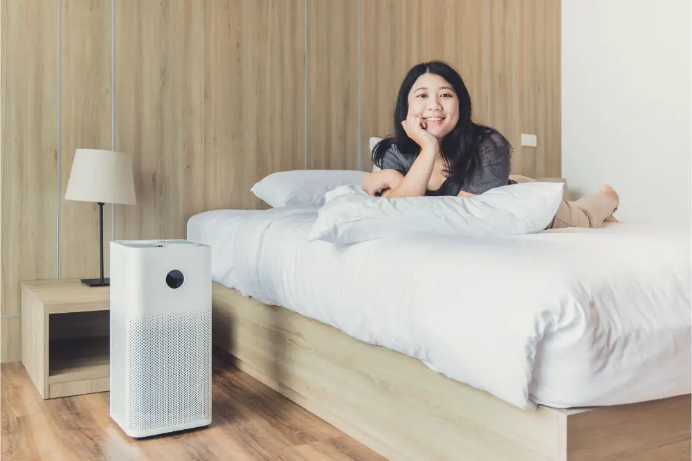 Woman at home bedroom happy enjoy with air purifier