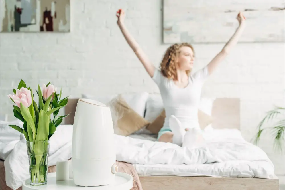 girl stretching in bedroom with air purifier and tulips