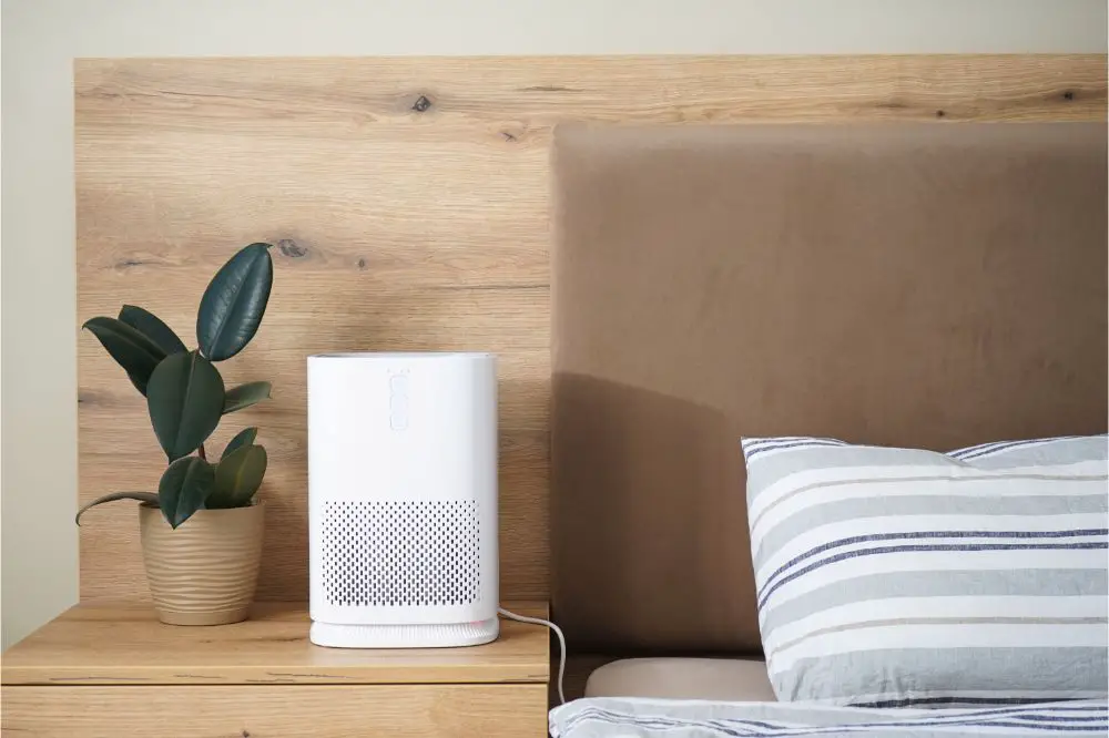 Modern air purifier in the bedroom by the bed