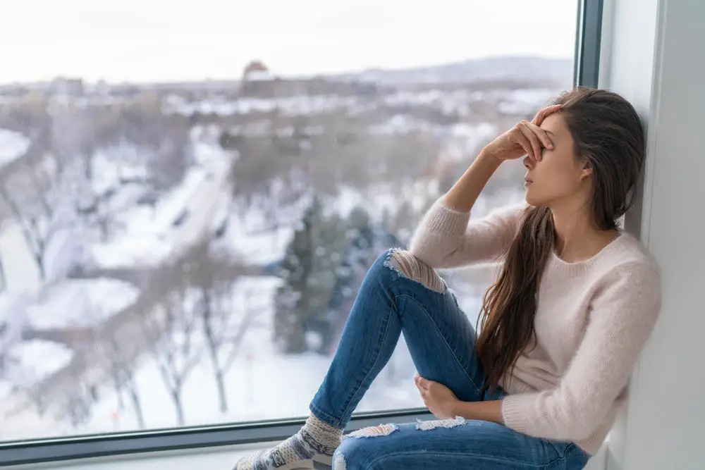 Seasonal affective disorder SAD depression winter season anxious alone young girl feeling lonely - stress, anxiety, melancholy emotion at home. Mental health problem.