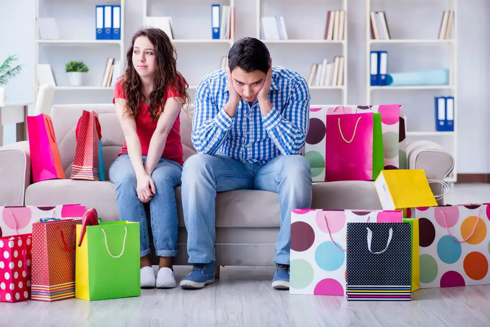 Young pair after shopping with many bags